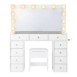 White makeup vanity table with drawers, illuminated mirror, and matching stool