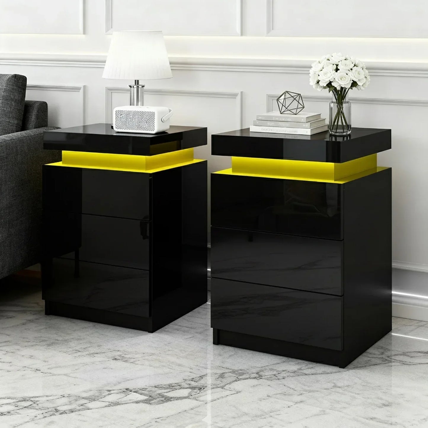 Modern black nightstands with yellow LED lights in a stylish living room setting