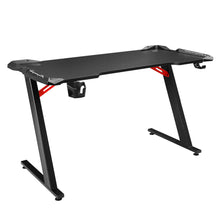 Black gaming desk with red accents, cup holder, and Z-shaped legs for PC setup