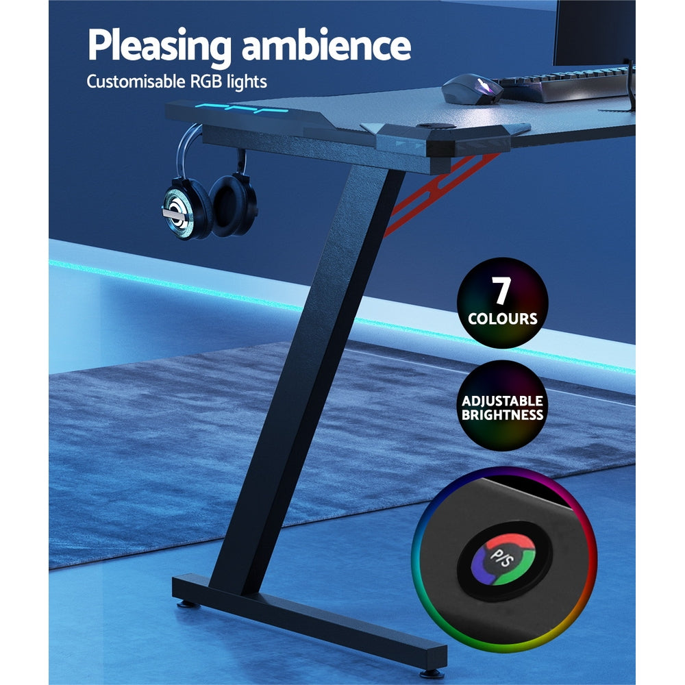 Gaming desk with customizable RGB lights, 7 colors, adjustable brightness, headset hook, and sleek black frame