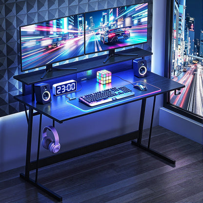 Gaming desk setup with dual monitors, RGB keyboard, speakers, and neon city view