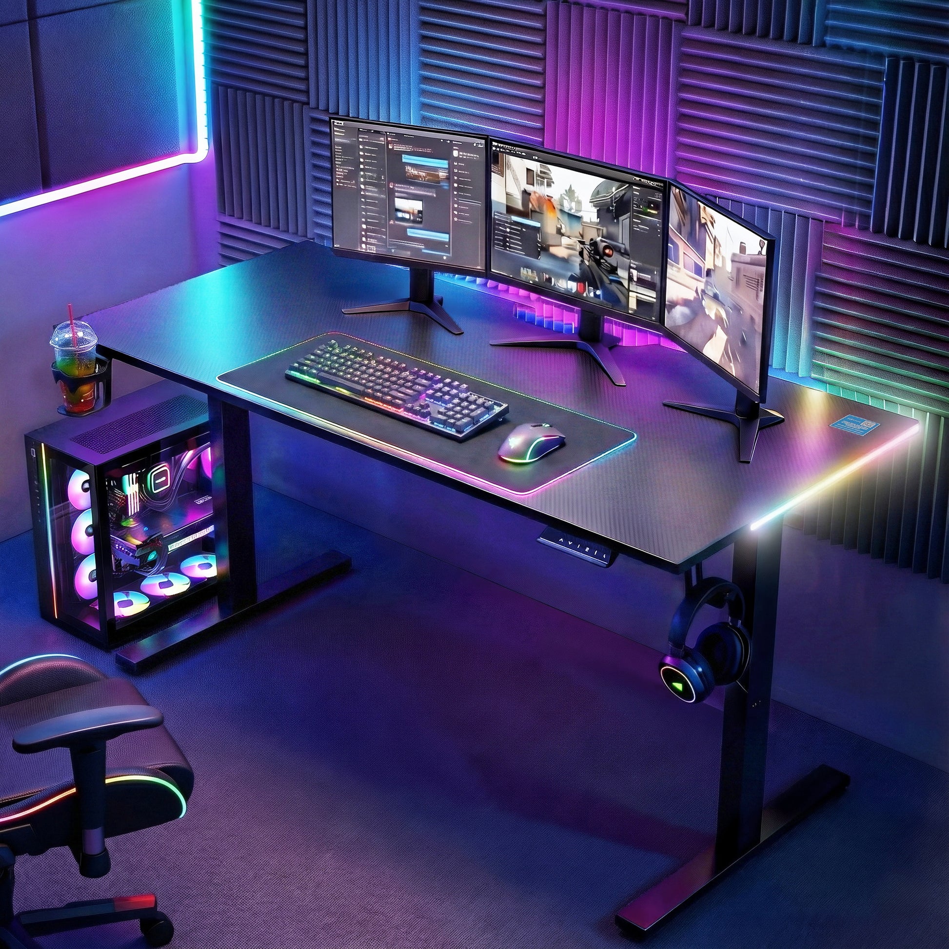 RGB gaming desk setup with triple monitors, mechanical keyboard, PC tower, and neon LED lighting for immersive gameplay
