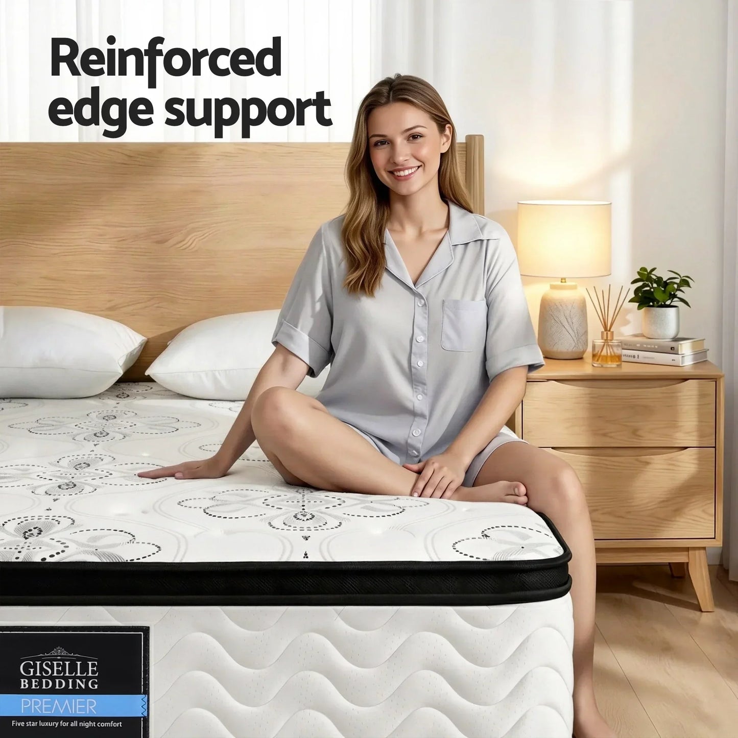 Woman smiling on a Giselle Bedding Premier mattress with reinforced edge support in modern bedroom