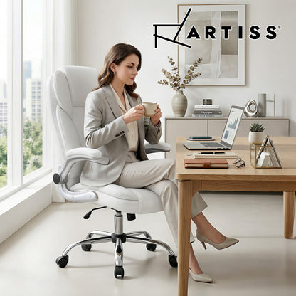 White ergonomic office chair with woman working at desk, modern home office setup