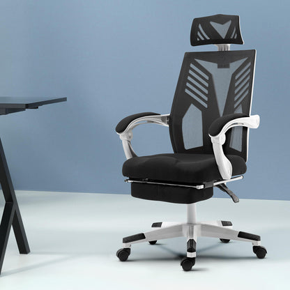 Black mesh office chair with headrest, adjustable arms, and wheels for ergonomic desk setup