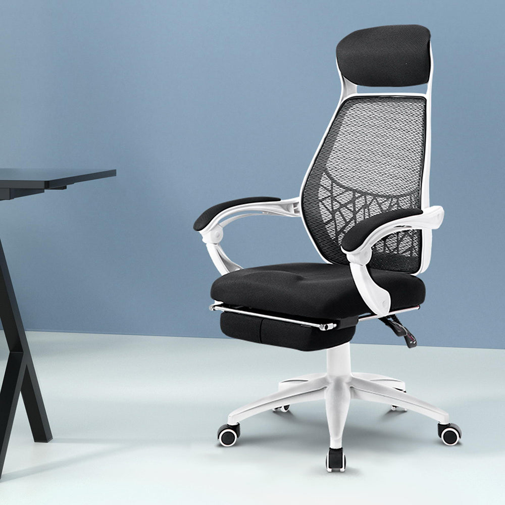 Ergonomic office chair with mesh back, adjustable armrests, and footrest, ideal for home or workspace comfort.