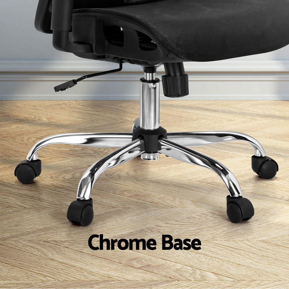 Black office chair with chrome base and casters on wooden floor