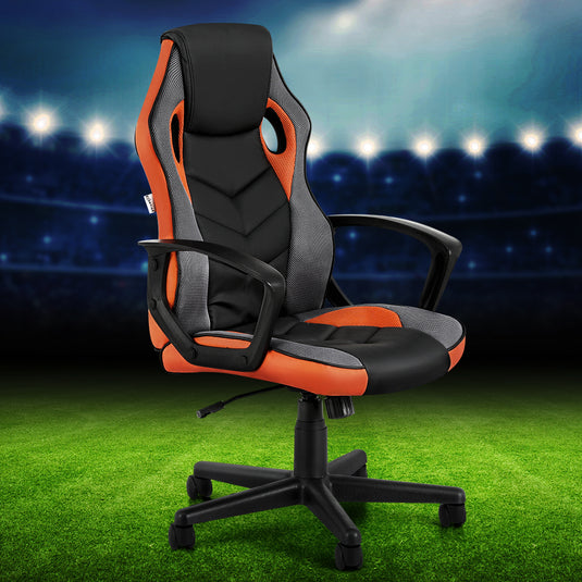 Black and orange gaming chair with ergonomic design on green turf background