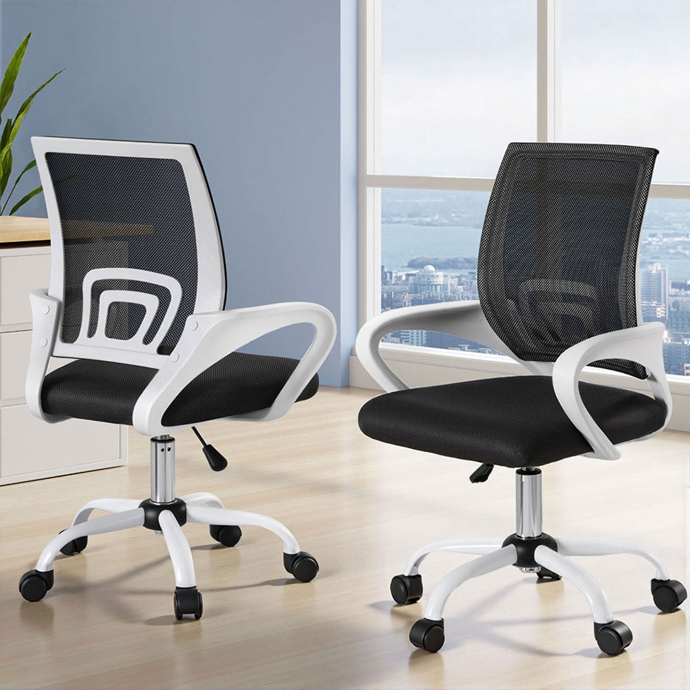 Modern mesh office chair with white frame, black seat, and rolling casters in bright home office setting