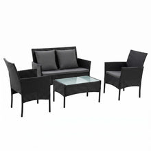 Black rattan outdoor lounge set with two single sofas, a bench sofa and a table