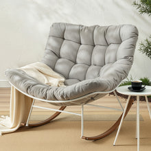 Gray tufted rocking chair with cozy blanket, modern home decor
