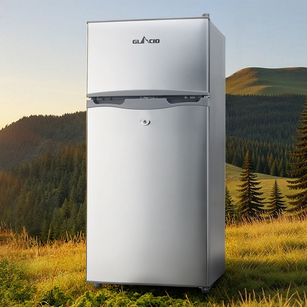 Glacio silver two-door fridge freezer in outdoor mountain setting, compact design for home use