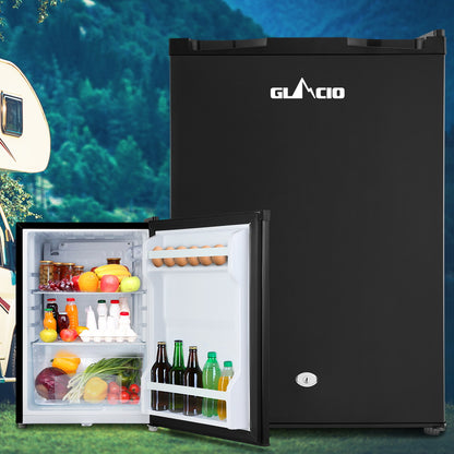 Black Glacio mini fridge with open door, stocked with drinks, eggs, and fresh produce, ideal for camping or small spaces.