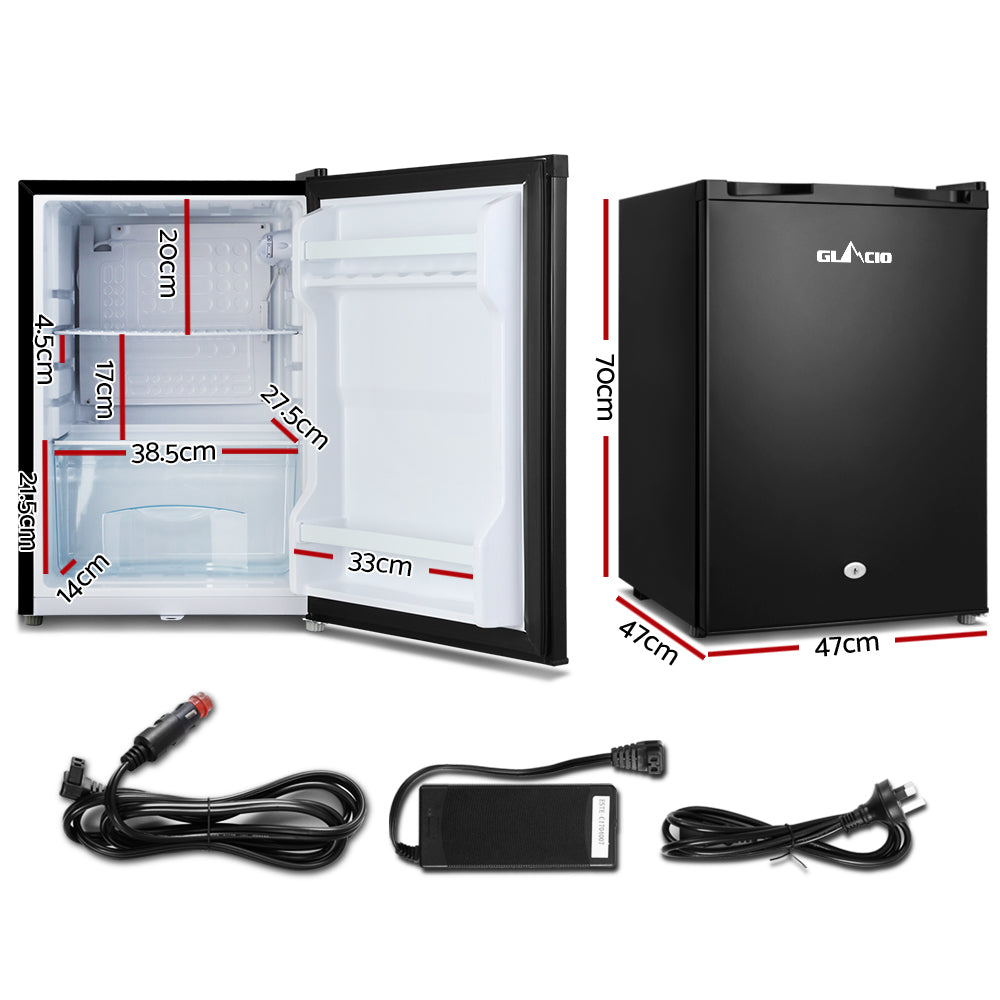 Compact black mini fridge with dimensions, car adapter, and power cords for home or travel use