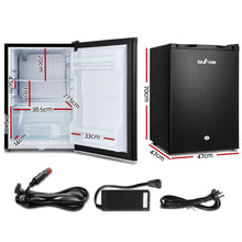Compact black mini fridge with dimensions, car adapter, and power cords for home or travel use