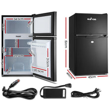 Compact black mini fridge with dimensions, car adapter, and power cords for home or travel use