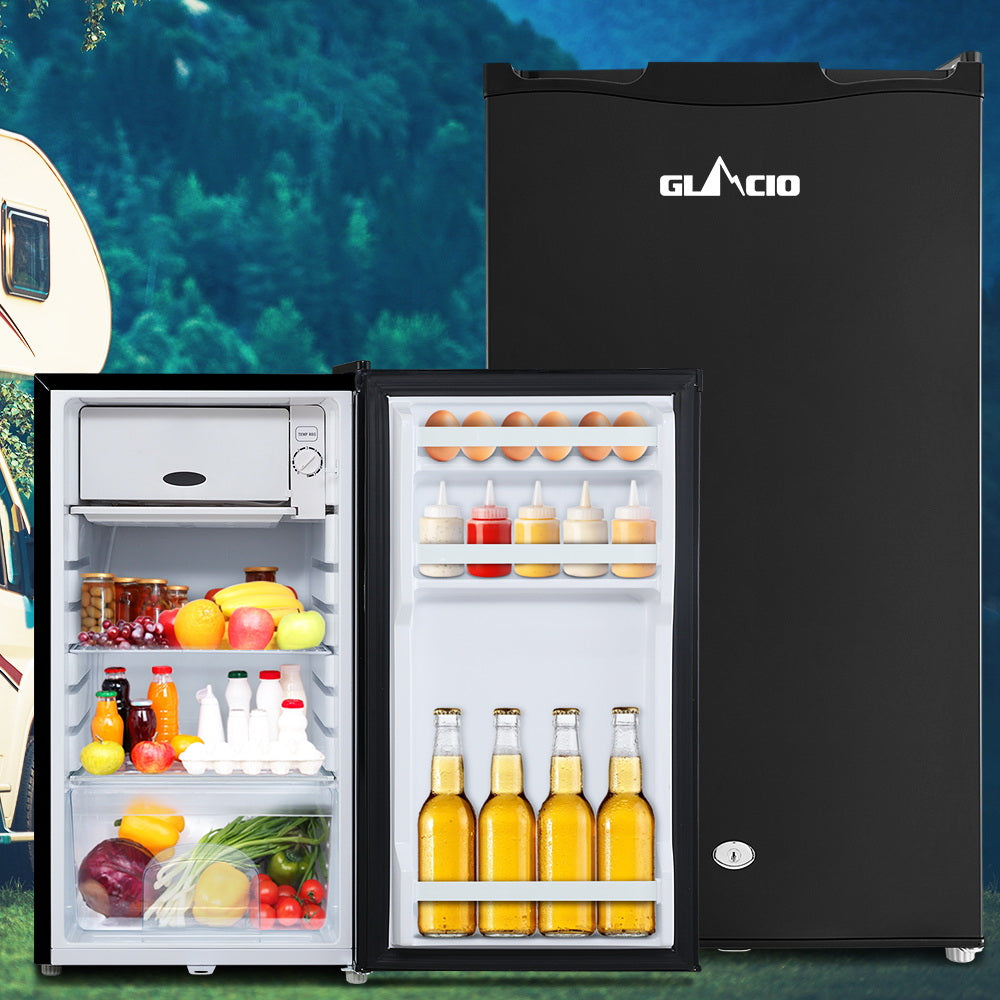 Compact GLACIO mini fridge stocked with drinks, eggs, and fresh produce, ideal for camping or small spaces.