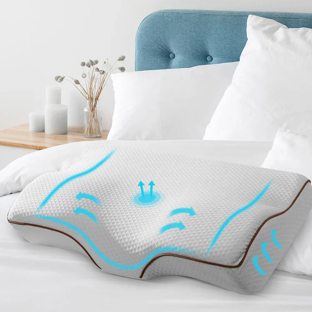 Ergonomic gray memory foam pillow with airflow design on white bed with blue headboard
