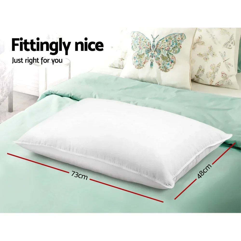 White pillow 73cm by 48cm on light green bed with butterfly decorative cushions