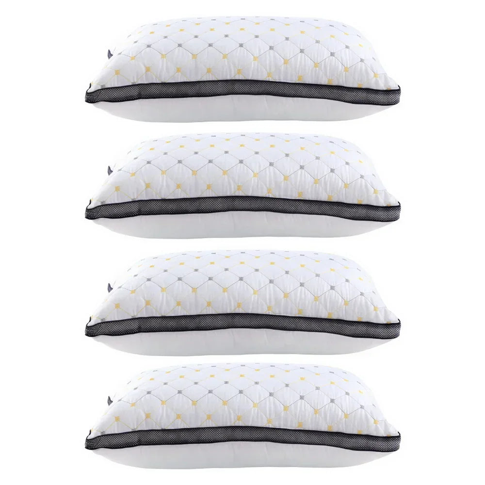 Stack of four white decorative pillows with yellow and gray diamond pattern and black mesh trim