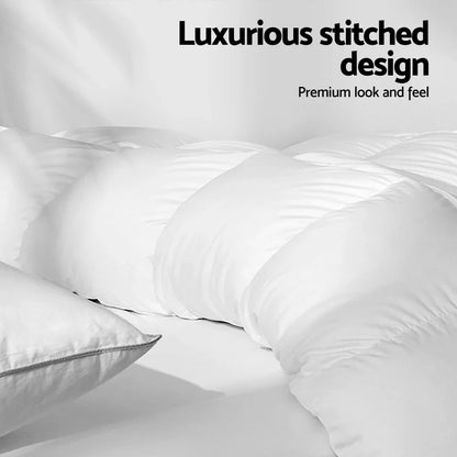 White goose down quilt with stitched design and matching pillow on a bed