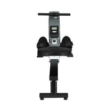 Black and silver rowing machine with digital display, foot straps, and padded seat on white background