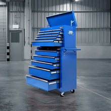 Blue rolling tool chest with multiple open drawers in an industrial warehouse setting