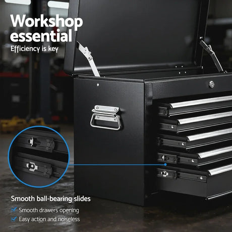 Black workshop tool chest with smooth ball-bearing slides and multiple open drawers on workshop floor