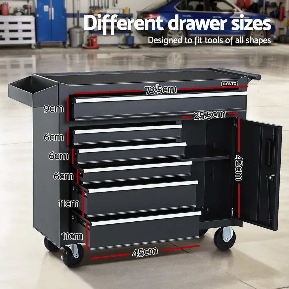 Black metal tool cabinet with different drawer sizes and dimensions labeled, on wheels in a garage setting