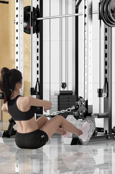 Woman using rowing machine in modern gym with power rack and mirrors