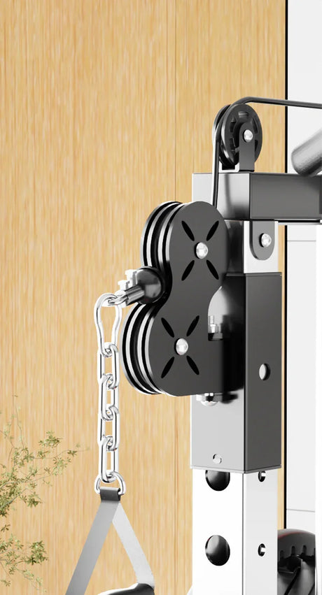 Close-up of a home gym cable pulley system with chain and black metal housing
