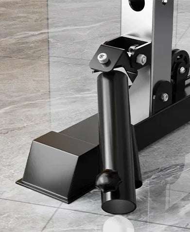 Black metal fitness equipment stand on gray marble floor, close-up view.