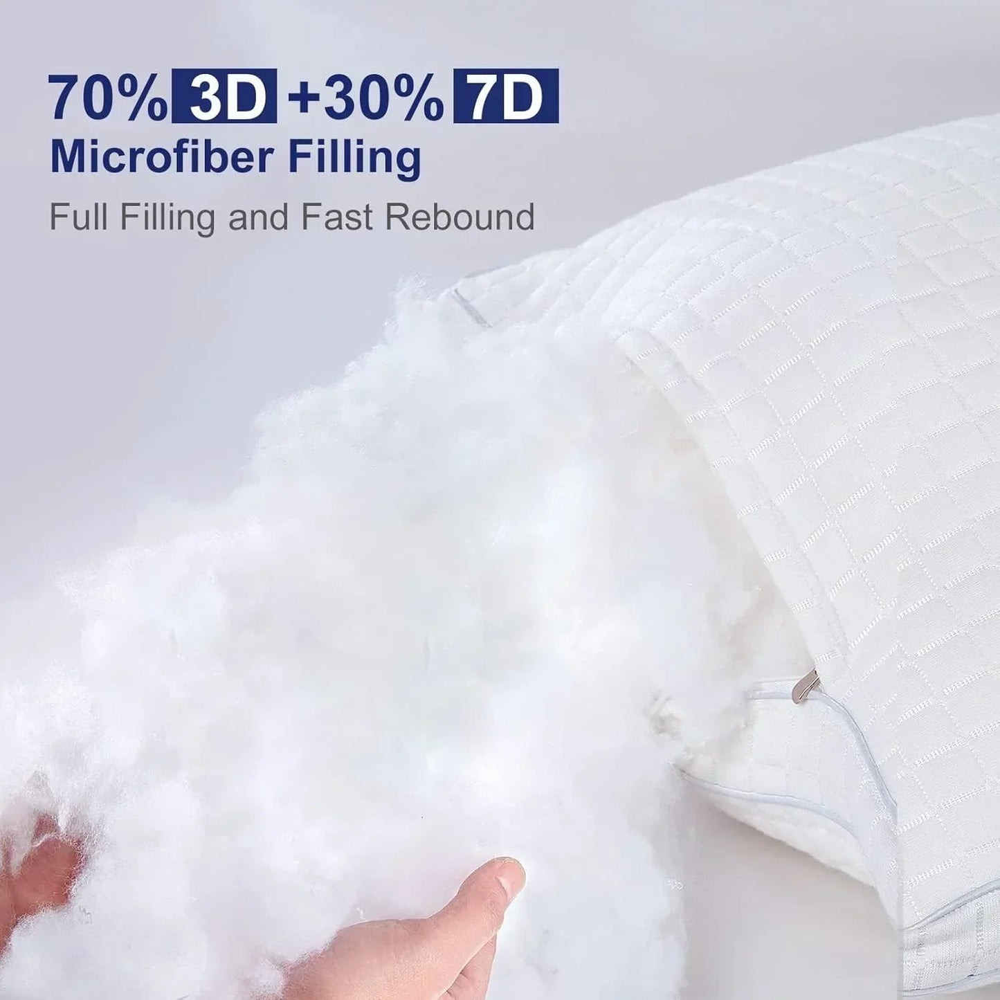 Hands holding fluffy white 3D and 7D microfiber filling from a textured white pillow with zipper