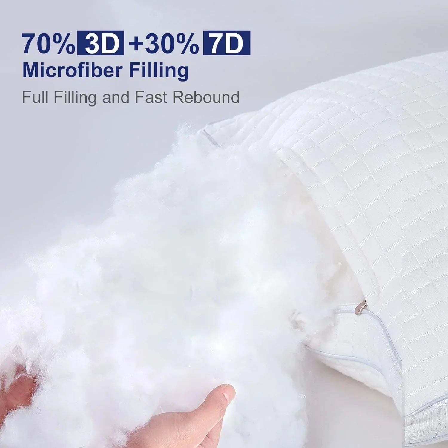 Hand holding fluffy white 3D and 7D microfiber filling from a white pillow with textured cover