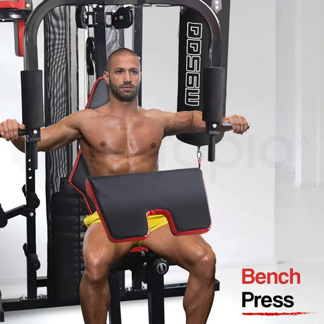 Shirtless man using home gym bench press machine for chest workout in fitness room