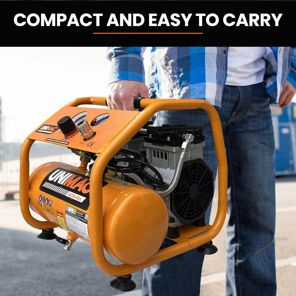 Person carrying a compact portable air compressor with orange frame outdoors