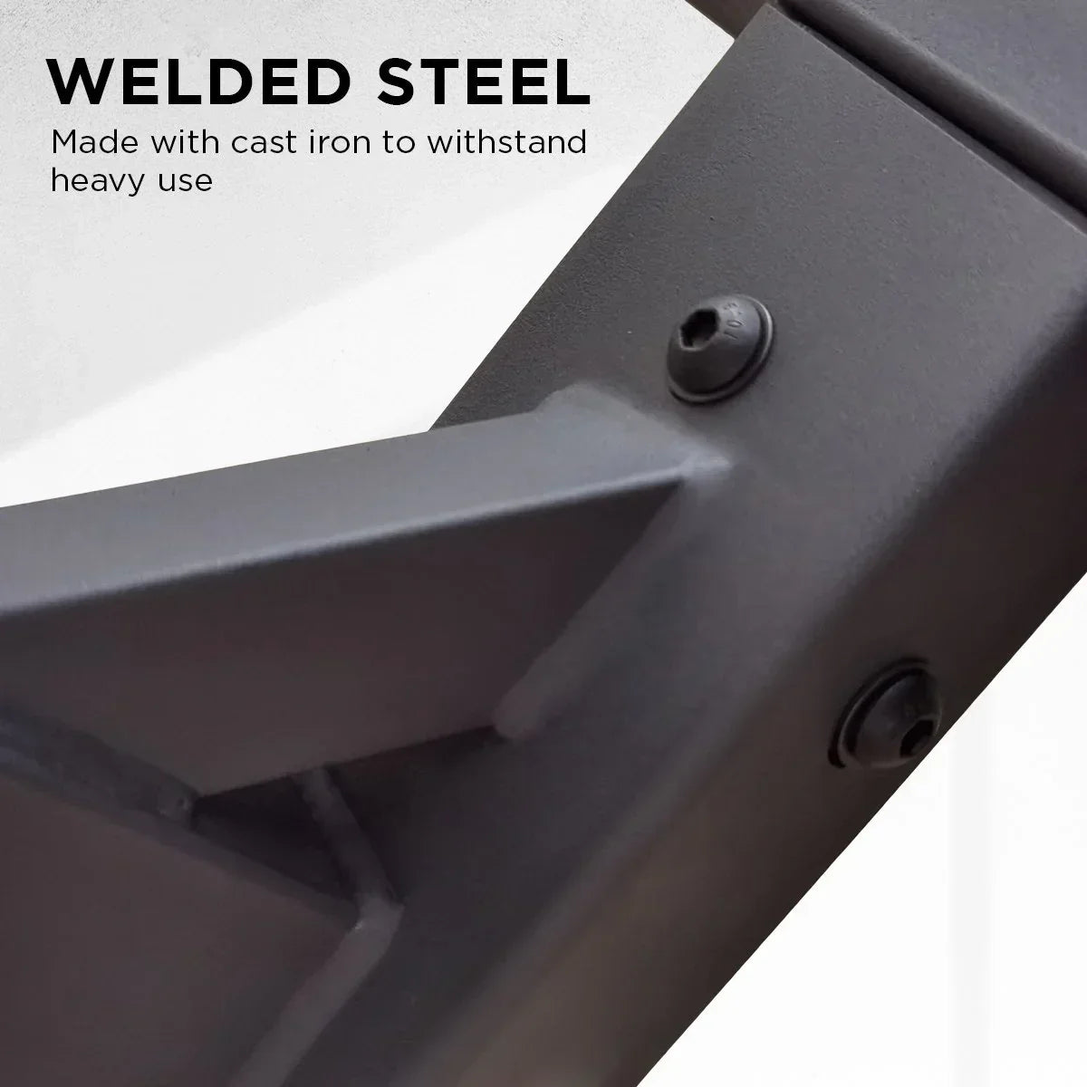 Close-up of black welded steel frame with cast iron screws, highlighting durable heavy-use construction