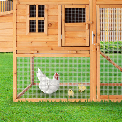 Wooden chicken coop with wire mesh, housing white hen and chicks on grass, ideal for backyard poultry.