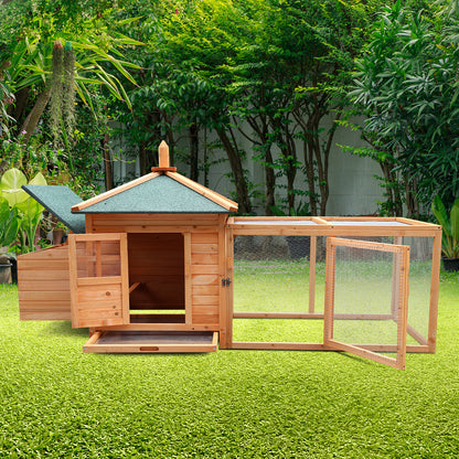 Wooden rabbit hutch with green roof and wire run, set on grass in garden
