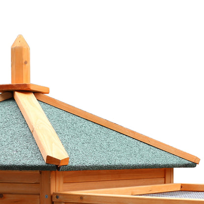 Wooden chicken coop with green shingle roof and pointed finial, ideal for backyard poultry housing