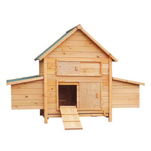 Wooden chicken coop with green roof, ramp, and nesting boxes for backyard poultry