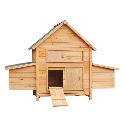 Wooden chicken coop with green roof, ramp, and nesting boxes for backyard poultry