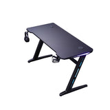 Black gaming desk with RGB lighting, headphone hook, and cable management for PC setup