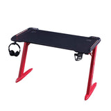 Black gaming desk with red legs, headphone hook, and cup holder for PC setup