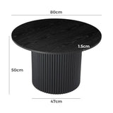 Black round coffee table with fluted base, wood grain finish, and dimensions labeled