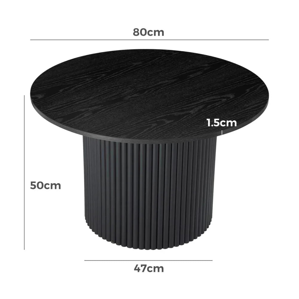 Black round coffee table with fluted base, wood grain finish, and dimensions labeled