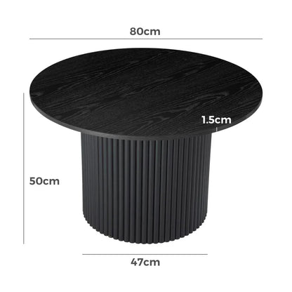 Black round coffee table with fluted base, wood grain finish, and dimensions labeled