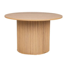 Round oak dining table with fluted wooden base and natural finish