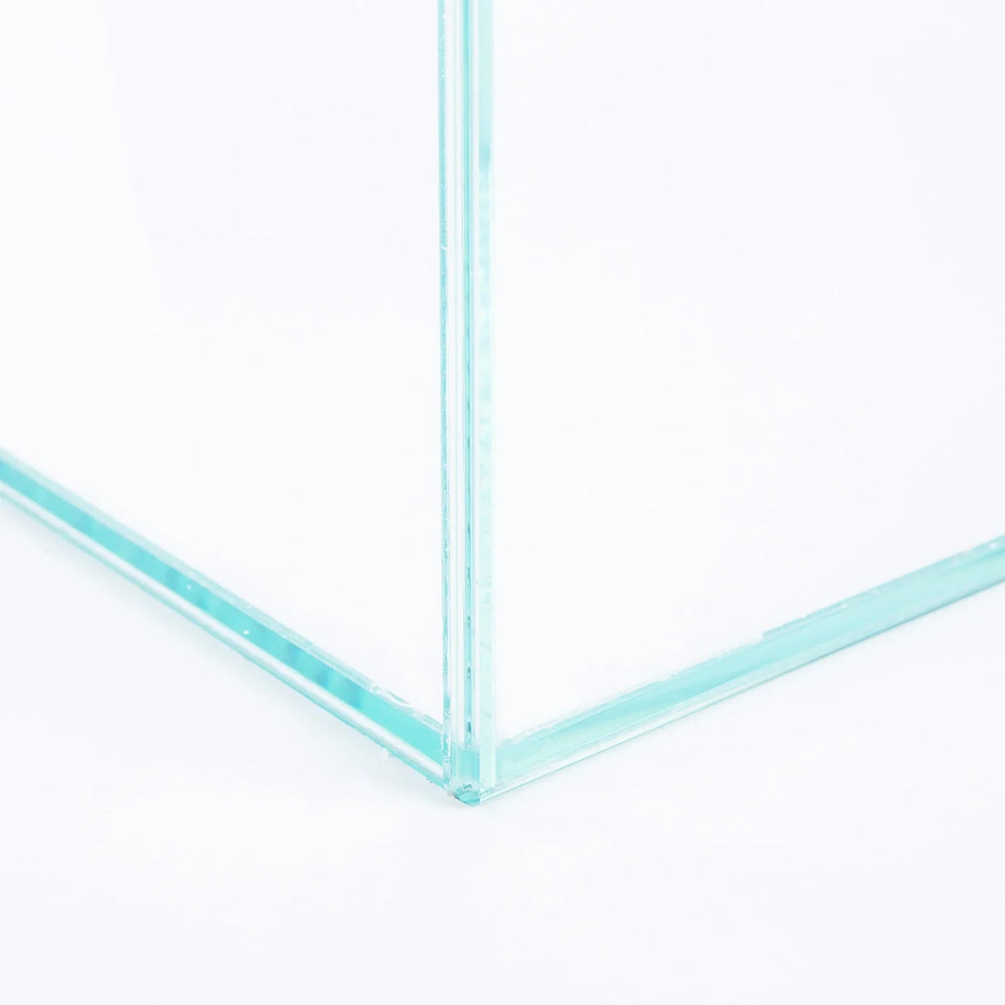 Close-up of a clear glass aquarium corner with silicone-sealed transparent panels