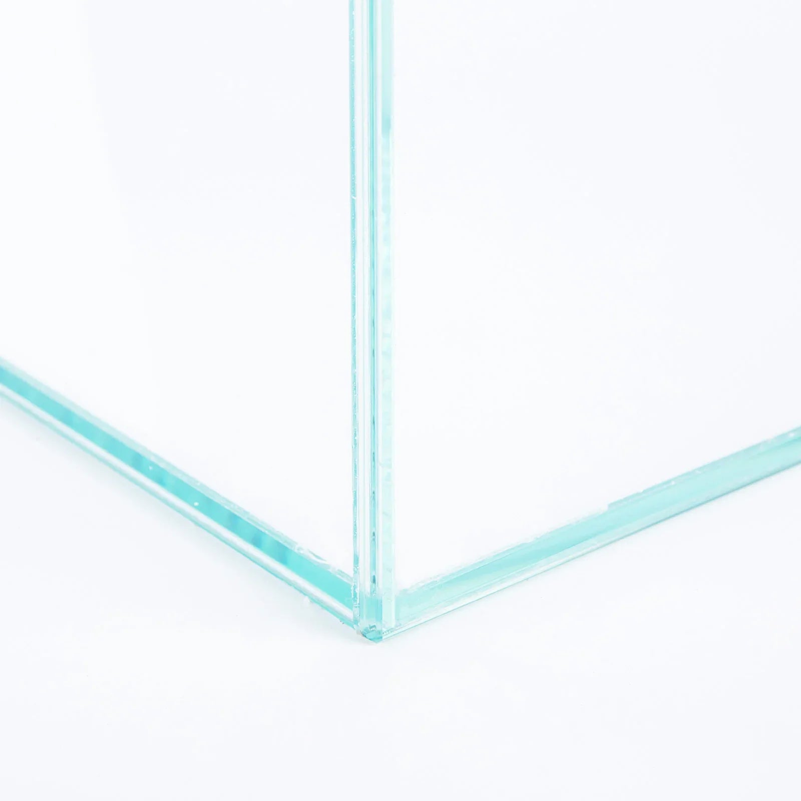 Close-up of a clear glass aquarium corner with silicone-sealed transparent panels